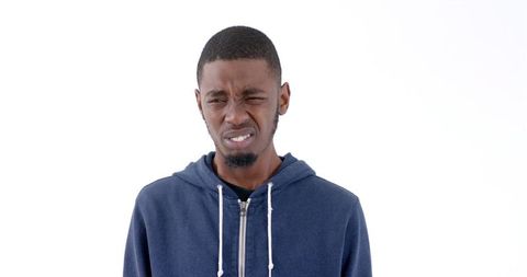 Young Man in Blue Hoodie Expressing Confusion on White Background - Download Free Stock Images Pikwizard.com