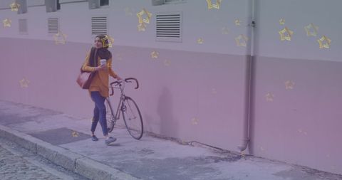 Woman walking bicycle on urban street