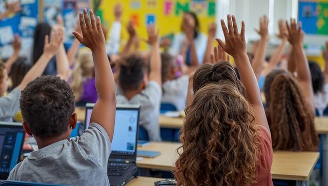 Engaged diverse classroom: students raising hands