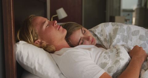 Peaceful couple relaxing and napping in bedroom
