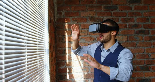 Man Experiencing Virtual Reality at Home in Sunlit Room - Download Free Stock Images Pikwizard.com