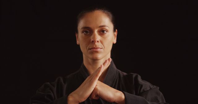 Female Martial Artist in Black Gi Demonstrating Focus and Discipline - Download Free Stock Images Pikwizard.com