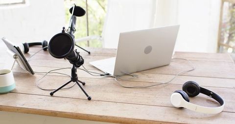 Minimalist Recording Workspace with Microphone and Laptop