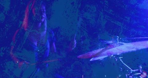 Female drummer energizing club stage with dynamic performance