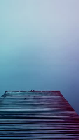 Vertical video showing slatted deck planks rising into teal gradient sky, minimal abstract