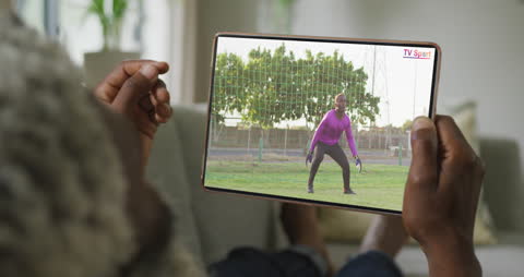 Relaxing with Tablet while Watching Soccer Game