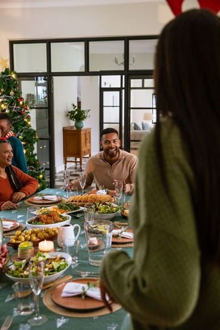Diverse Family Celebrating Christmas Dinner Together at Home