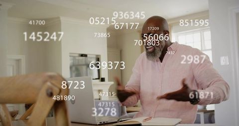 Senior man celebrating online win with floating data overlays during remote work