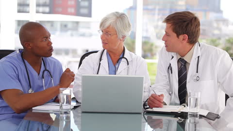 Medical Team Discussing Patient Care in Office Setting