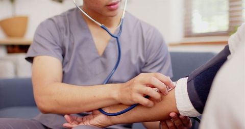 Male Physiotherapist Conducting Arm Examination in Clinic