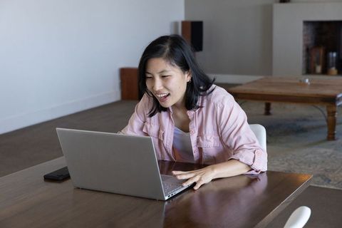 Woman Enjoying Online Work in Relaxed Home Setting