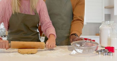 Diverse Couple Baking Together in Rustic Kitchen Setting