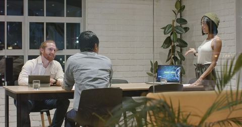 Diverse Team Collaborating in Night Office Meeting