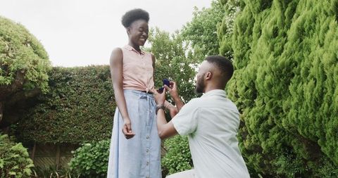 Romantic garden proposal capturing surprise and love