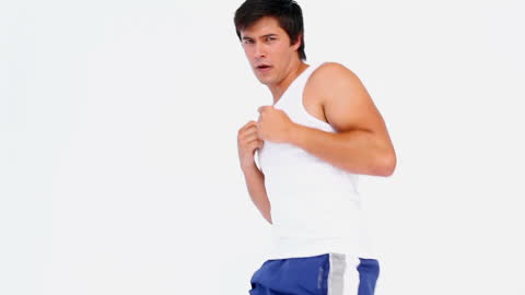 Man Practicing Kickboxing in White Studio