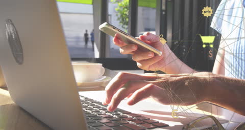 Person Using Laptop and Smartphone with Digital Network Overlay