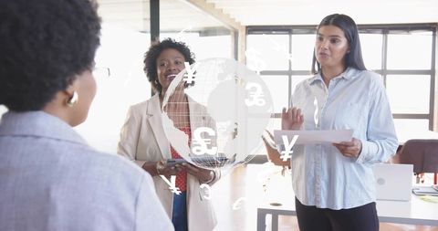 Women collaborating with global finance technology in modern office