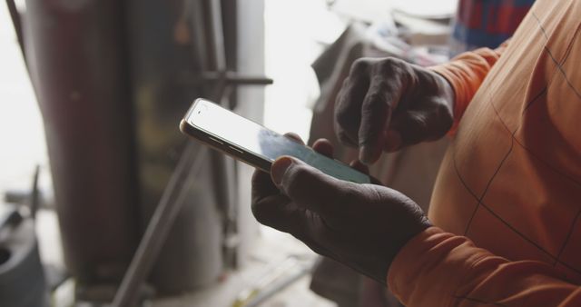 Close-up of Worker Using Smartphone in Industrial Setting - Download Free Stock Images Pikwizard.com