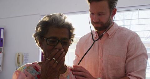Doctor Examines Senior Woman with Stethoscope in Clinical Setting