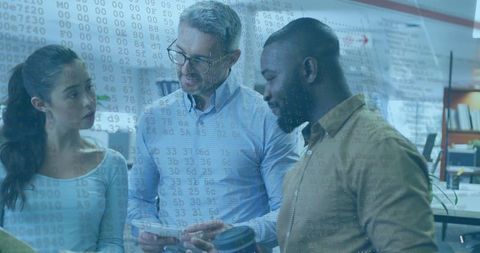 Diverse team collaborating with technology in office environment