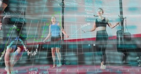 Women Jumping Rope in Gym with Financial Charts Overlay for Fitness Tech and Cardio