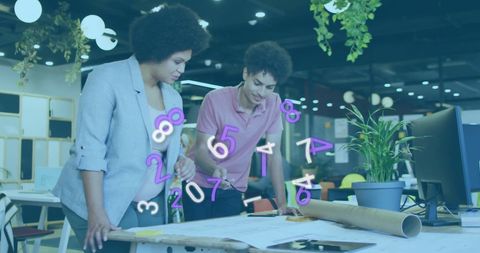 Modern office team reviewing architectural plans with digital overlay