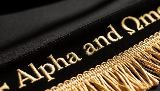 Luxurious gold alpha and omega embroidered velvet band featuring ornate tassel fringe