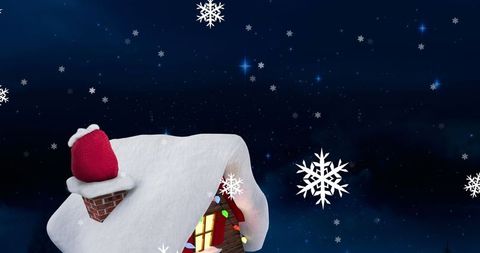 Winter Wonderland: Snowflakes over Festive Snowy Cottage at Night