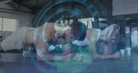 Couple holding forearm plank with futuristic hud overlay in warehouse gym partner fitness