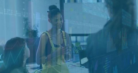 Team Collaboration in Modern Office Environment with Analytics Display