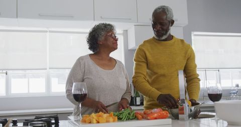 Senior Couple Bonding While Preparing Healthy Meal in Modern Kitchen