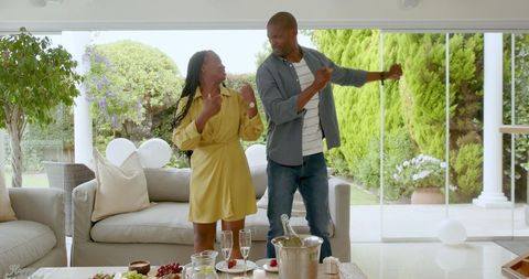 Joyful couple celebrating special moment at home