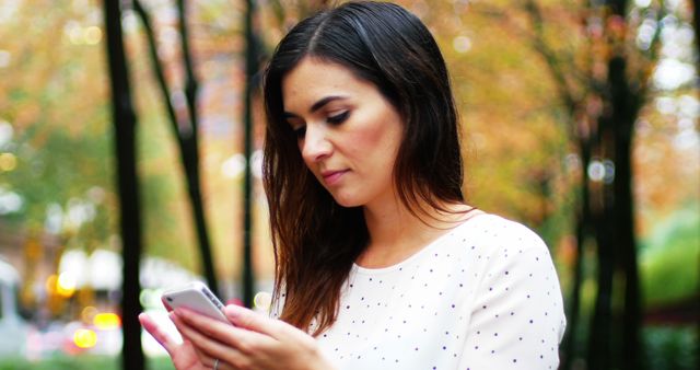 Woman Messaging on Smartphone in Park - Download Free Stock Images Pikwizard.com