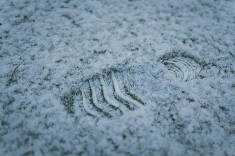 Single Boot Print Embedded in Snowy Ground Closeup