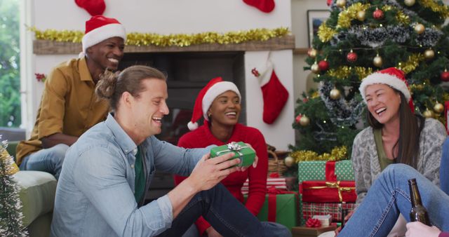 Diverse Friends Exchanging Gifts by Christmas Tree - Download Free Stock Images Pikwizard.com