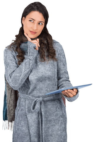 young woman dressed in cozy winter clothing holds tablet thoughtfully. perfect for technology, winter fashion, or lifestyle themes highlighting digital creatives or remote work in colder seasons. useful in advertisements or articles about tech-savvy fashion or seasonal activities.