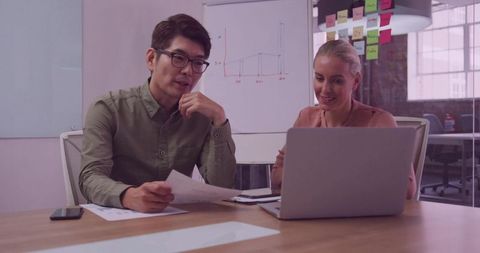 Colleagues Collaborating in a Modern Office with Technology Tools