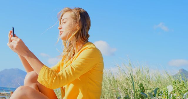 Blonde Woman in Yellow Shirt Using Smartphone Outdoors - Download Free Stock Images Pikwizard.com