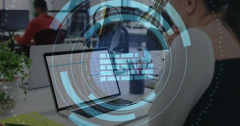 Woman Typing on Laptop in Coworking Office with Holographic Data HUD and Spreadsheet