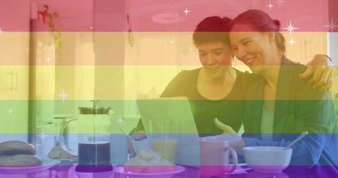 Lesbian Couple Relaxing with Tablet Over Breakfast, Pride Theme