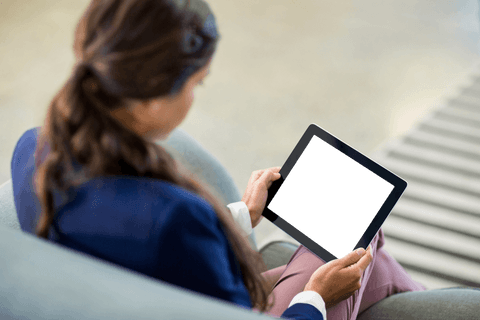 Woman in office holding transparent digital tablet black screen