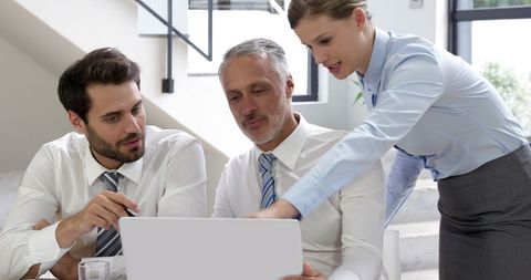 Business Team Collaborating on Project Over Laptop in Modern Office - Download Free Stock Images Pikwizard.com