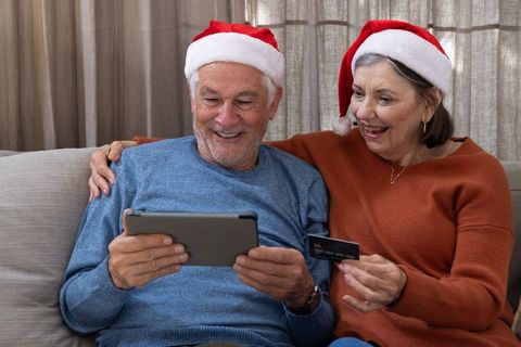 Senior Couple Shopping Online with Tablet During Christmas Holiday