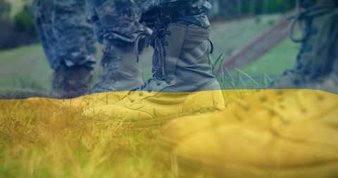 Boots of Soldiers Overlaid on Ukraine Flag Symbolizing Military Presence