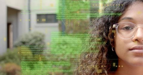Young woman analyzing code with digital overlay in modern courtyard studying tech education