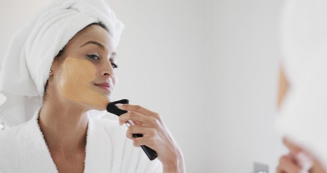 Woman Applying Foundation with Brush in Bathroom Mirror, Focused on Smooth Complexion - Download Free Stock Images Pikwizard.com