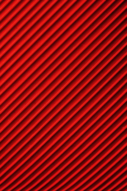 Close up of 3d lines texture on red background. Background with abstract texture and design concept