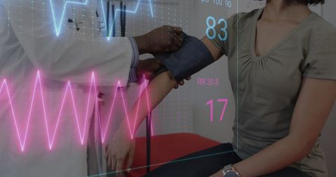 Healthcare Professional Checking Patient Blood Pressure with Digital Interface