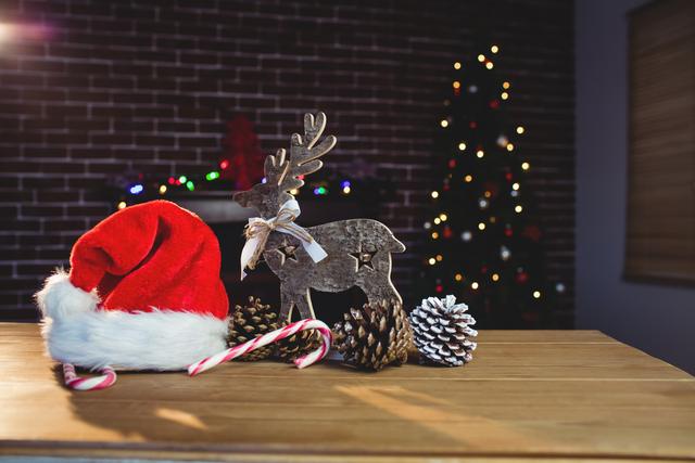 Christmas Decorations on Wooden Table with Santa Hat and Reindeer - Download Free Stock Photos Pikwizard.com