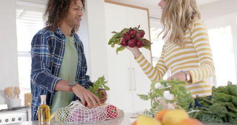 Happy Couple Unpacking Groceries in Modern Kitchen